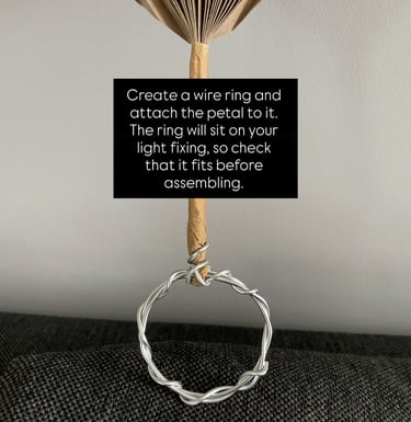 accordion-style folded flower petal for DIY lamp shade, taped with brown paper tape and wire ring