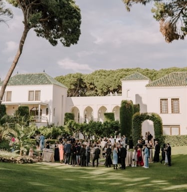 Garden event at Villa El Rincon with guests gathered among lush greenery