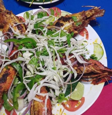 a plate of grilled fish with a salad