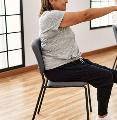 Chair yoga with arms and legs straight out to train core
