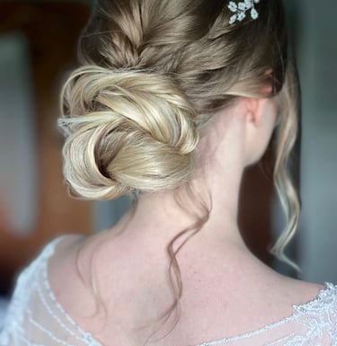 a woman with wedding hair with a flower in her hair