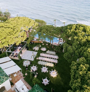 Aerial view of luxury destination wedding setup by the sea at Villa El Rincon Marbella