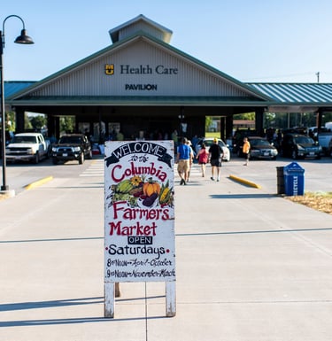Photo taken of the Columbia Farmer's Market sign in front of the Farmer's Market pavilion