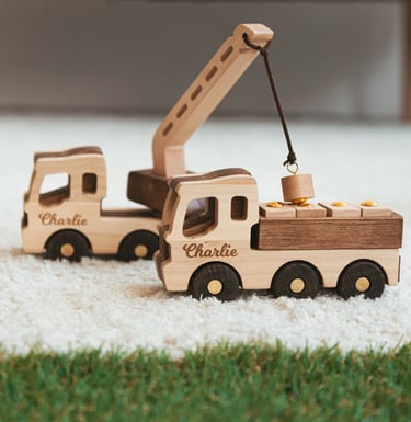 a wooden toy truck with a crane on it