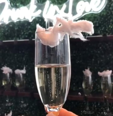 Drunk in love neon sign with a grass champagne wall rental for a baby shower