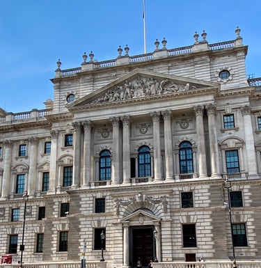 a large portland stone building with traditional windows and beautiful carved stone figurines 