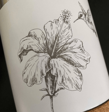 a bottle of wine with a hummingbird on it