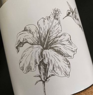 a bottle of wine with a hummingbird on it