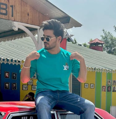 a man sitting on top of a car