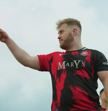 a man in a red shirt pointing at something