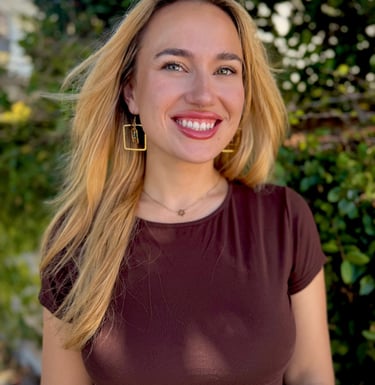 owner of business headshot in front of greenery