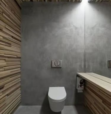 Modern minimalist bathroom featuring a wall-hung toilet, concrete walls, and wood slat accents.
