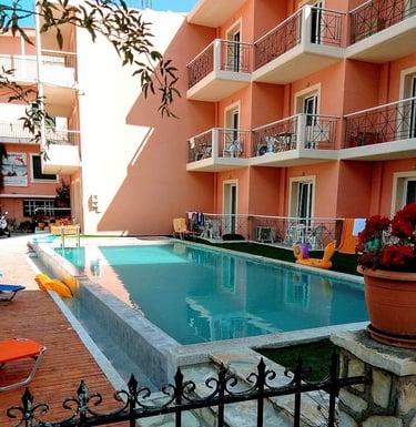 a pool with a pool and chairs and a fenced in area