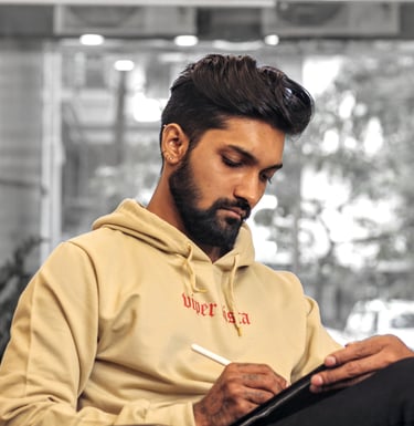 Photo of a Tattoo Artist designing on Ipad