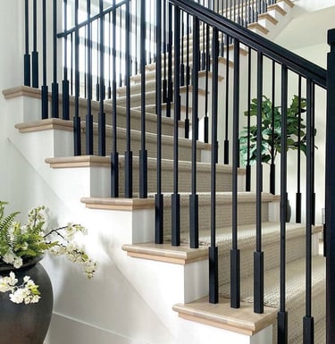 Modern matte black aluminum staircase railing for luxury villa interior.