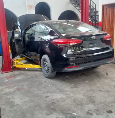a car in a garage with a car in the background