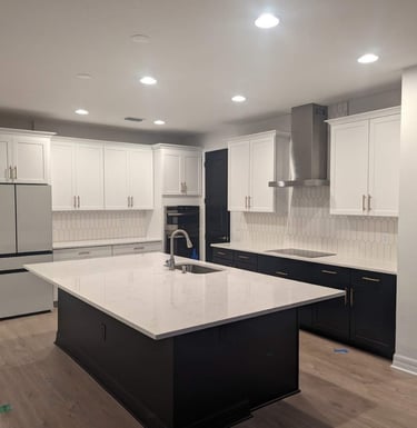 a kitchen with a large island and a refrigerator