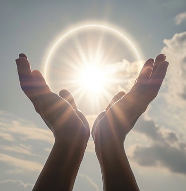 a person holding their hands up to the sun