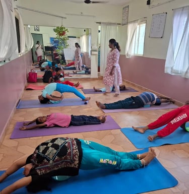 a group of people doing yoga exercises on a mat