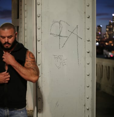 a man with a beard and tattoos on his chest