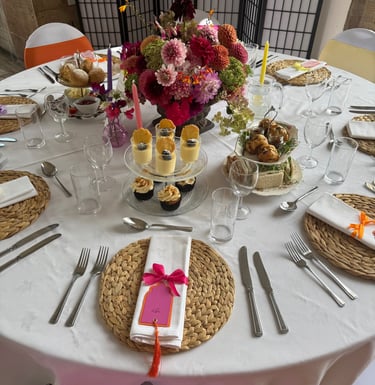 a wedding breakfast table with afternoon tea and flowers