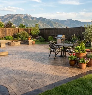 Finished stamped concrete patio in a South Jordan backyard with outdoor dining set.