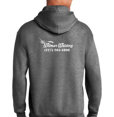 a man in a gray shirt and glasses is smiling