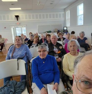 A picture of some members in a meeting.
