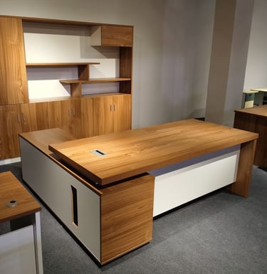Modern executive wooden office desk with a white L-shaped base and matching wall storage cabinets.