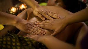 Lady getting a four hands massage