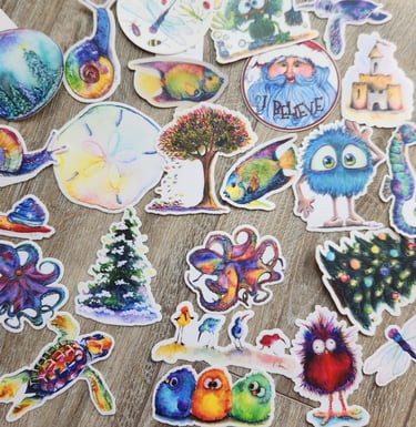 Collection of colorful watercolor stickers featuring animals, nature, and whimsical characters on a wood surface.