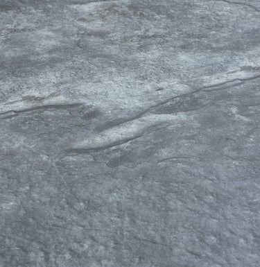 A soft stone slate featuring a unique black and gold veining pattern, ideal for elegant wall designs