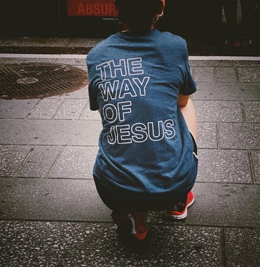 a person showing a tshirt at the back 'The Way of Jesus'