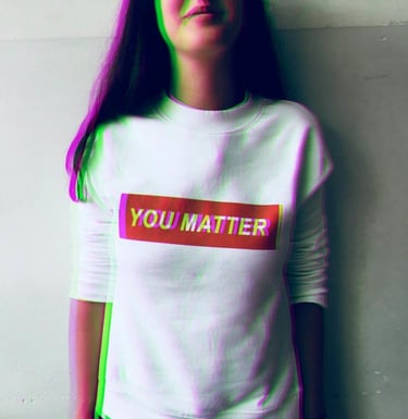 a woman with long hair and a white shirt with the words you matter