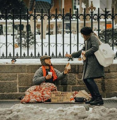 Person giving food to someone in need during winter.