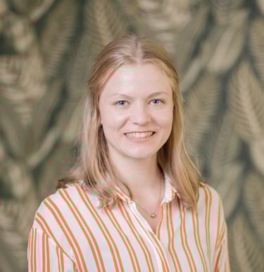a woman in a striped shirt and jeans