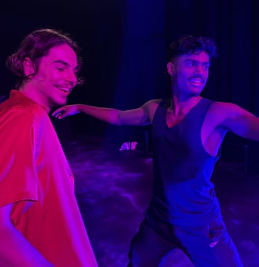 two men standing in front of a stage