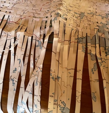 student work at the NAS, presenting a world map cut into strips and rebraided