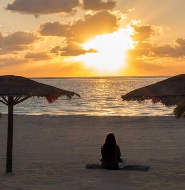 grieving woman on beach in Mexico at retreat
