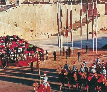 a group of people in a parade in front of a castle