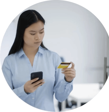 Women holding her mobile phone while looking at her bank card