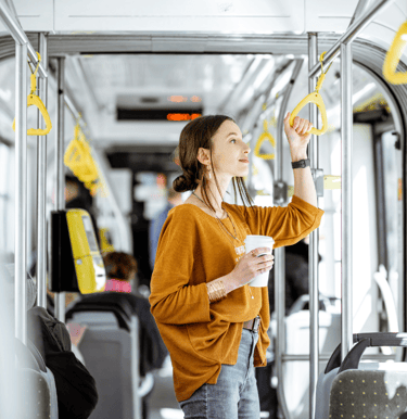 a woman in a yellow sweater is holding a cup of coffee