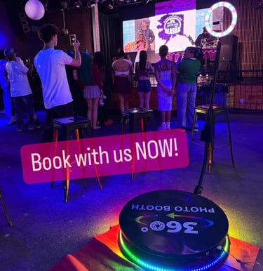 360 photo booth in red green yellow blue lights spinning with crowd present