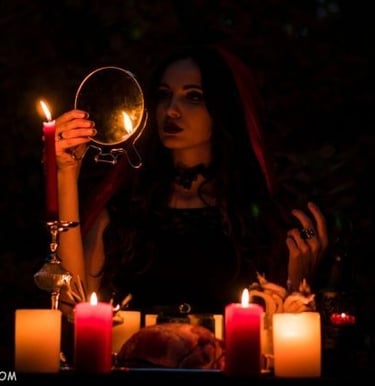 Witch looking into a handheld mirror by candlelight