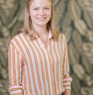 a woman in a striped shirt and jeans