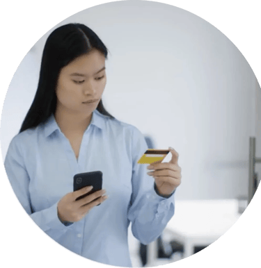 Women holding her mobile phone while looking at her bank card