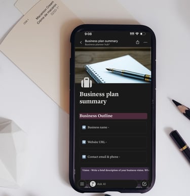 Business plan summary template displayed on a smartphone screen next to a pencil and desk accessories.