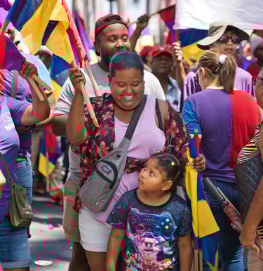 Smiling family in the crowd holding flags