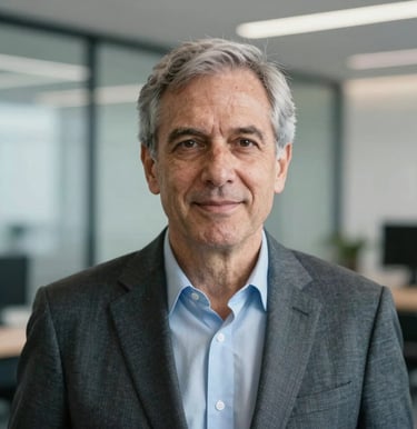 A corporate portrait of a senior tech executive in a brightly-lit modern North American / Global office. Professional attire, intelligent expression, soft blue and gray tones in the background, high-end photography style with shallow depth of field.