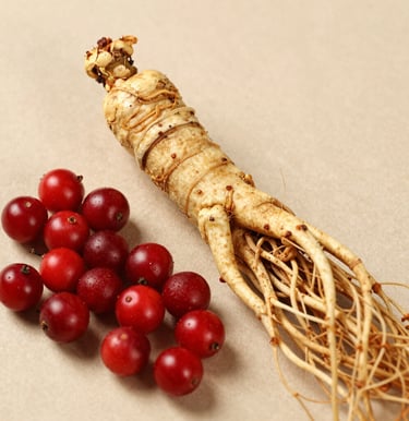 A woman over 40 enjoying a calm moment in her kitchen with CitrusBurn bottle and a cup of tea nearby.